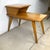 This authentic Heywood-Wakefield magazine table exemplifies the sculptural simplicity that established the company as one...