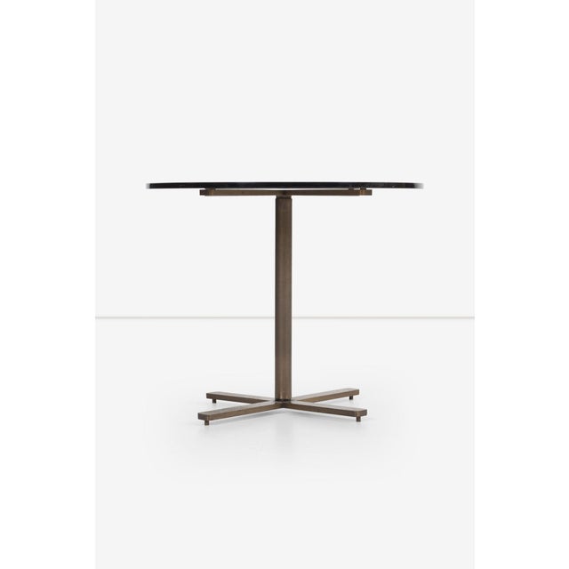 Nicos Zographos Bronze Base End Table with Tinted Glass Top 1970s This striking end table, designed by Greek-born...