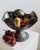 This vintage silver-plated copper bowl from the 1950s is a beautifully handcrafted piece featuring an elegant footed base...