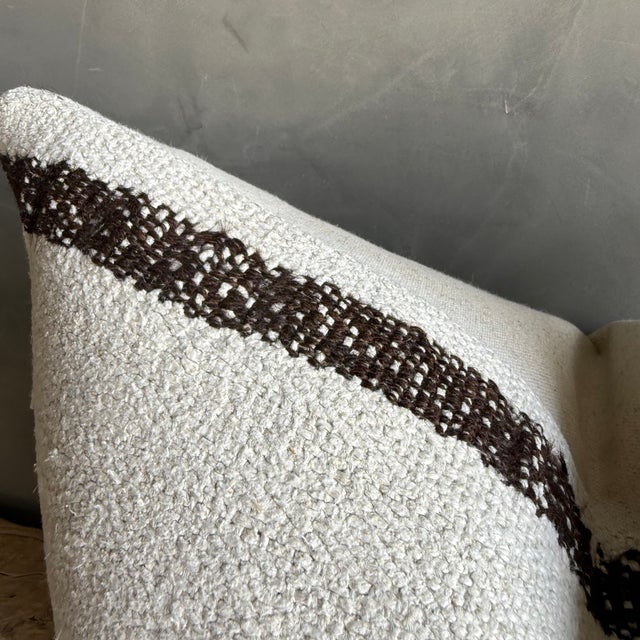 Creamy white hemp rug pillow with stripes. Soft hand, linen blend backing with zipper closure. Spot cleaning is...