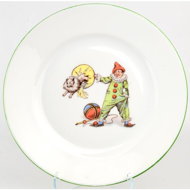 A 1920s-'30s nursery set, comprising of a plate, bowl and cup, embellished with charming images of circus performers....