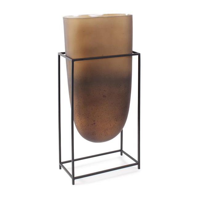 Expertly inset into a sleek flat black iron stand that seamlessly marries form and function. The bronze glass finish...
