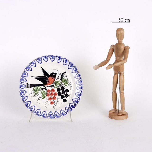 Group of six polychrome majolica plates with decorations of vegetal, animal and writing motifs. This piece is attributed...