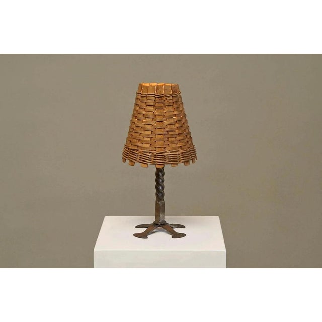 Mid century table lamp in wrought iron with woven rattan shade 1960s a characterful mid-century table lamp in wrought iron...