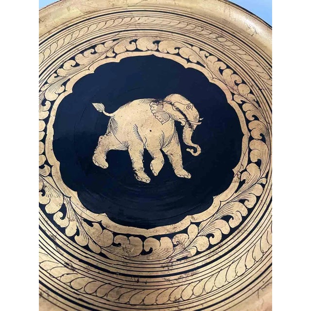 Collection of vintage, early 20th-century decorative wooden plates. Hand-painted lacquerware from Burma, featuring gold...