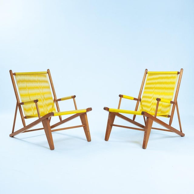 These bright yellow spaghetti lounge chairs embody the playful elegance of mid-century modern design. Crafted from solid...