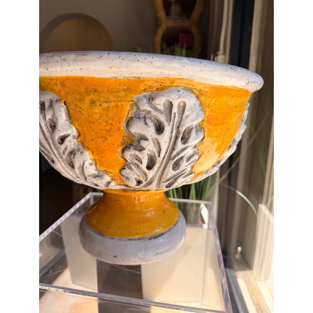 Add a vibrant pop of color to your home with this stylish ceramic planter, featuring a warm golden-yellow glaze and an...