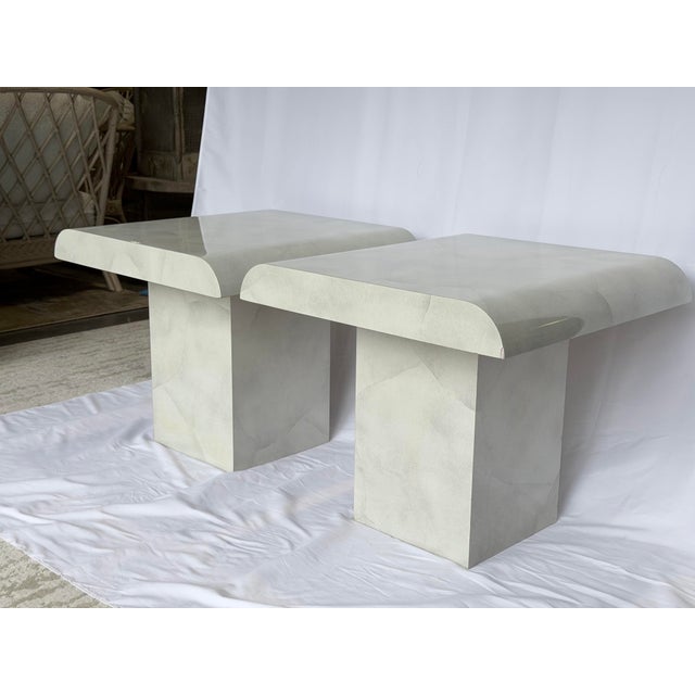 A striking pair of 1980s postmodern end tables featuring a faux Carrara marble laminate finish in soft, tonal neutrals....
