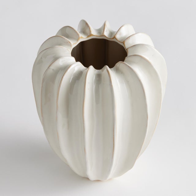 With a sculpted body and thickly applied glaze, this coastalinspired vase is a work of art. The handfinished details give...