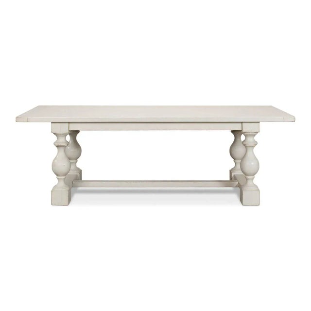 An English Country style antique white dining table with bold shapely turned baluster supports and an H stretcher base....
