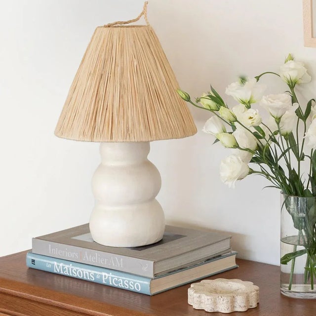 Handmade ceramic lamp in a wavy column form made from terracotta and white glaze. New natural raffia shade, brass stem...