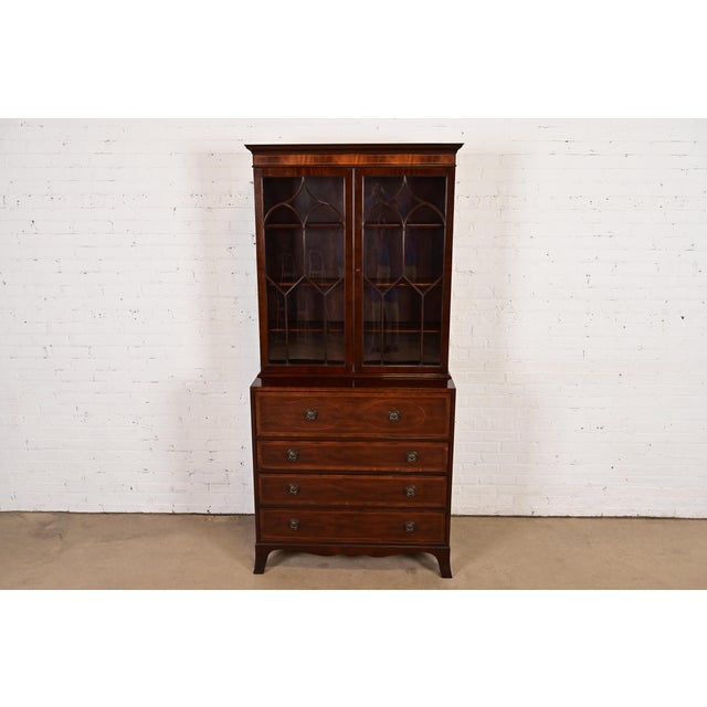 A gorgeous Georgian or Regency style bureau with drop front secretary desk and bookcase hutch top By Baker Furniture USA,...