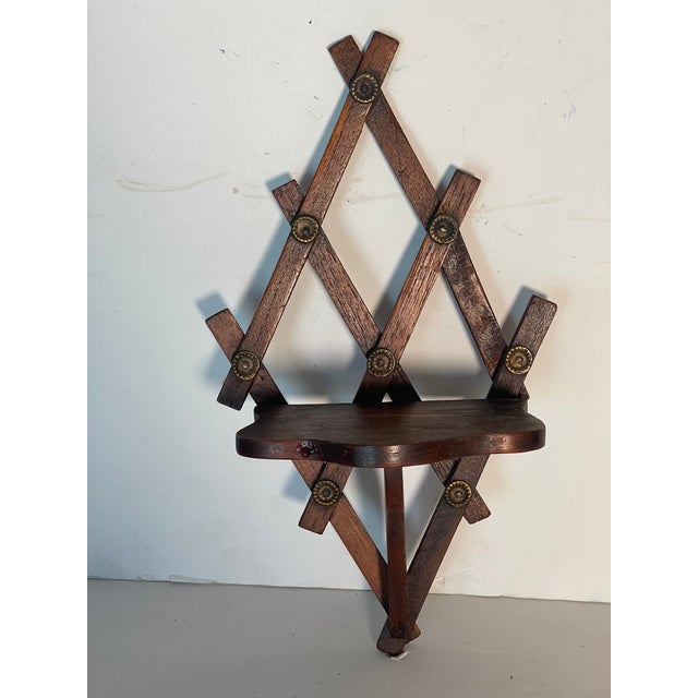 Antque small wooden shelf with brass nails.