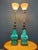 A striking pair of ceramic and brass table lamps designed by Edwin Cole for Stiffel, featuring bold turquoise glazed...