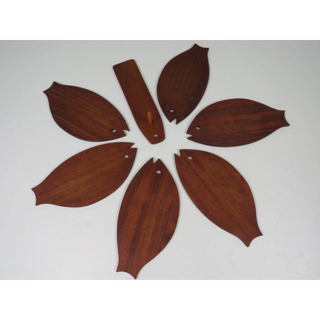 An exceptionally crafted wall-mounted set composed of 6 fish-shaped breakfast or serving boards in solid teak. Each board...