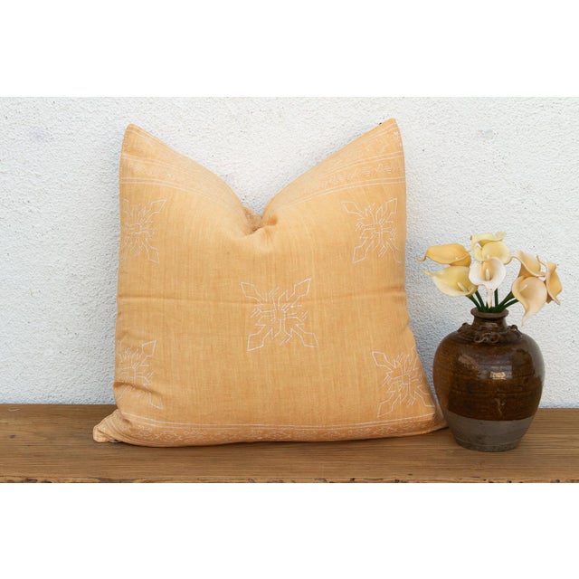 An eight-point star medallion, hand block-printed in white, traces softly across a warm, airy yellow linen ground on this...