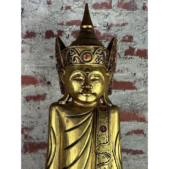 Large wooden sculpture of a MANDALAY BUDDHA from Burma 1970 in patinated gilded wood, inlay with red pearls. 1 old...