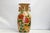 Our vase is has a detailed hand-painted Floral motif with a blue bird over a tan-toned surface. The curved form is...