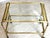 Elegant mid-century brass and glass bar cart from the 1960s, featuring a refined architectural frame with decorative...