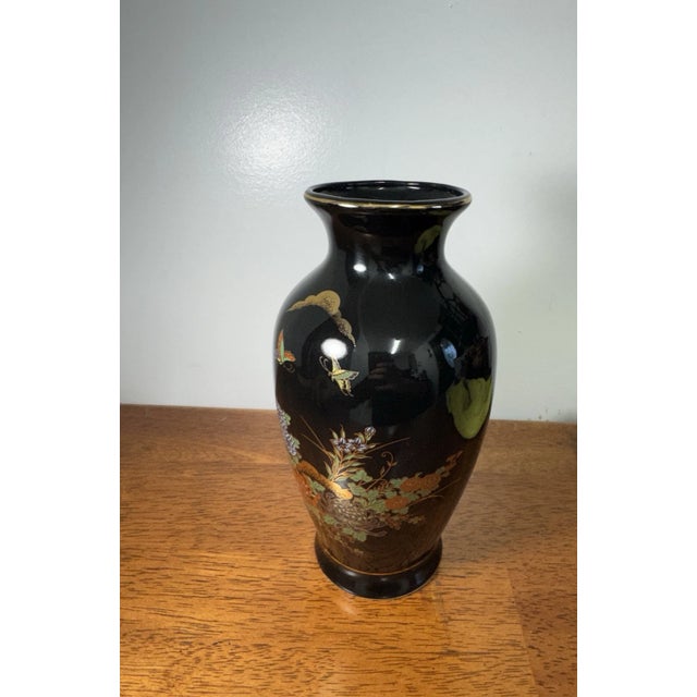 Beautiful vintage Japanese hand painted vase featuring a black gloss finish with floral and butterfly design accents and...