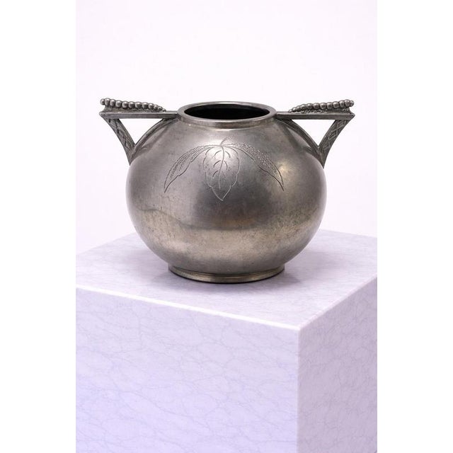 A refined and sculptural swedish art deco pewter vase by lundin & lundberg (l&l), dating to the 1930s. This elegant piece...