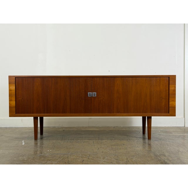 Hans J Wegner teak tambour door "President" credenza. Manufactured by RY Mobler, Denmark circa 1965. This piece has been...