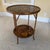 An exquisite 21st-century British Colonial style two-tier round accent table by the esteemed luxury maker, Century...