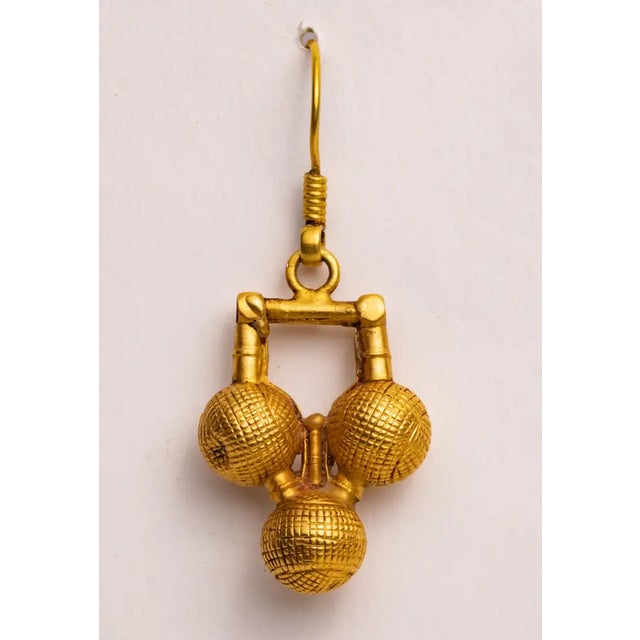 A pair of 18K gold South Indian dangle drop earrings hand-tooled testured design using the lost wax method. French wire...