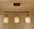 Mid Century Danish modern pendant light featuring a teak wood suspension and 3 opaline glass shades Dimensions: Height 58...