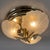 A refined and dramatic modernist ceiling or wall light featuring a composition of three shaped frosted glass diffusers on...