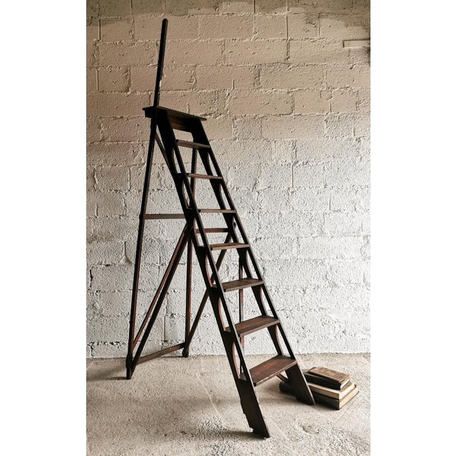 This folding oak library ladder dates from the 1920s. High-quality, delicate craftsmanship. - Height (standing & folded) =...