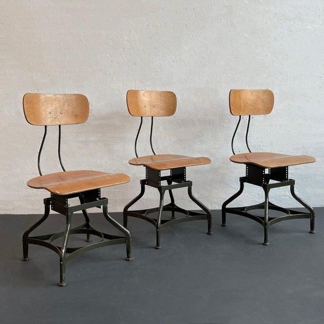 This set of three industrial, adjustable side shop chairs by Toledo Metal Furniture Co. feature the signature Toledo star...