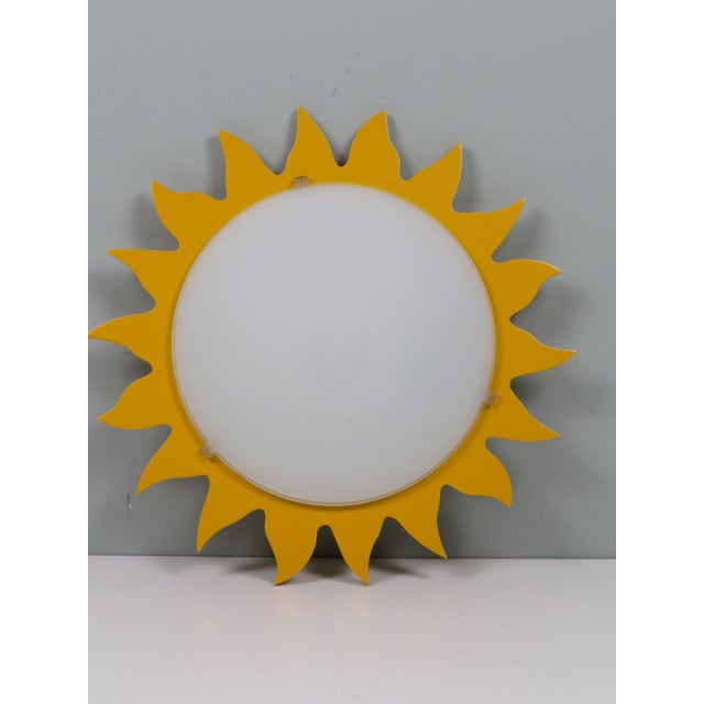 A striking vintage ceiling lamp by massive belgium, dating from the 1970s. This model combines a central opaline milk...