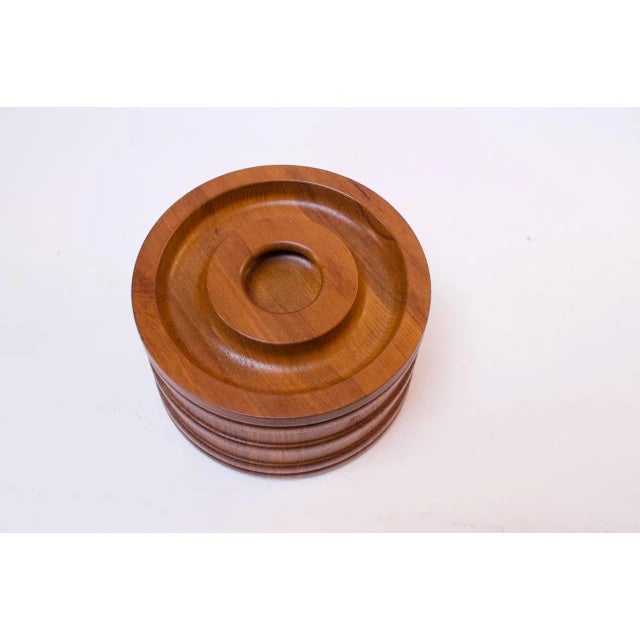 Round, teak ice bucket with black plastic interior insulation designed by Jens Quistgaard for Dansk (1960s, Denmark)....