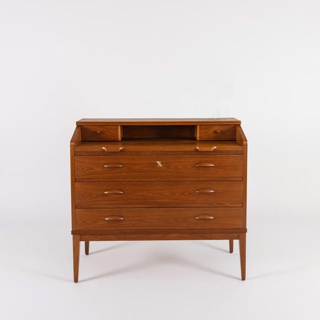 Elegant secretary desk/chest of drawers combination based on a 1960s design. Reduced, clean lines with a fine teak grain....