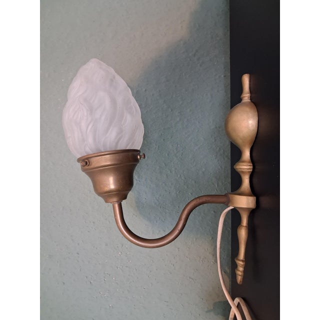 A very beatiful Art Noveau light ,wall lamp ,made in france with brass holder and floreal typical Art Noveau style smoked...