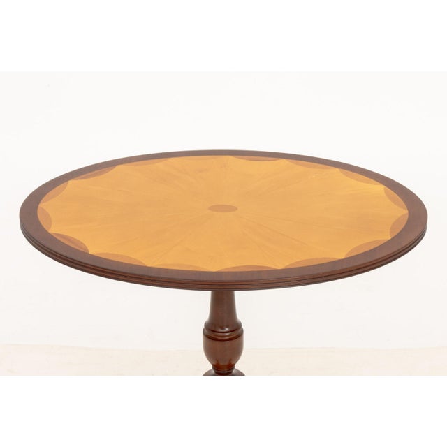 Bombay Company Oval Mahogany Occasional Table, with walnut starburst inlay to the top on pedestal base with four feet on...