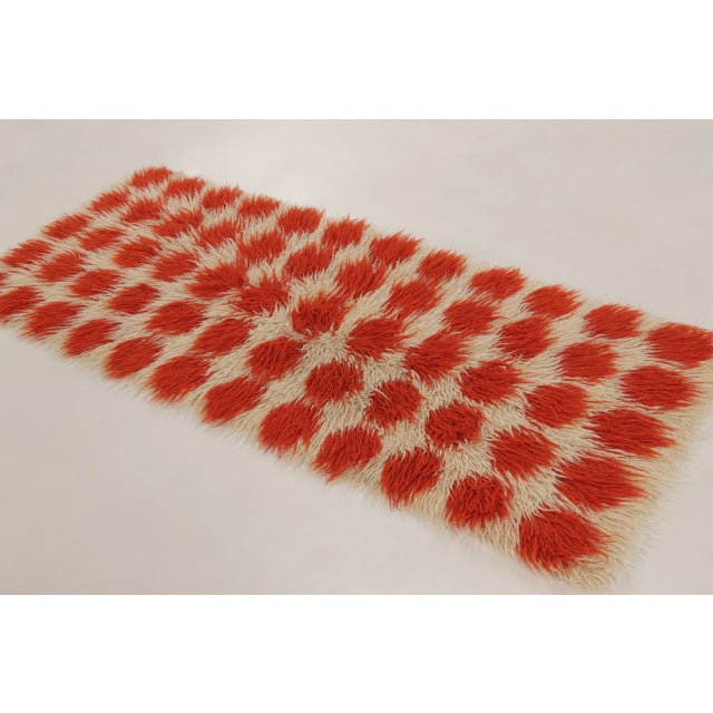 Hand-knotted in wool, this vintage 3x7 Turkish Tulu runner showcases an exuberant shaggy geometric design woven circa...
