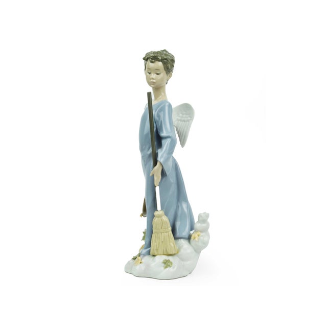 This charming Lladro porcelain figurine, titled "Autumn Sweeper" (Barrendero de Otoño), was designed by sculptor Joan...