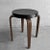 Classic, art deco, stackable stool by Thonet features bentwood legs with a black, 14 inch diameter, hard plastic, Bakelite...