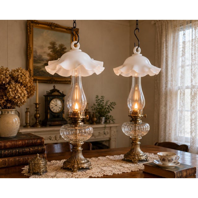 A charming pair of antique white milk glass hanging smoke bells featuring gracefully ruffled rims and integral glass...