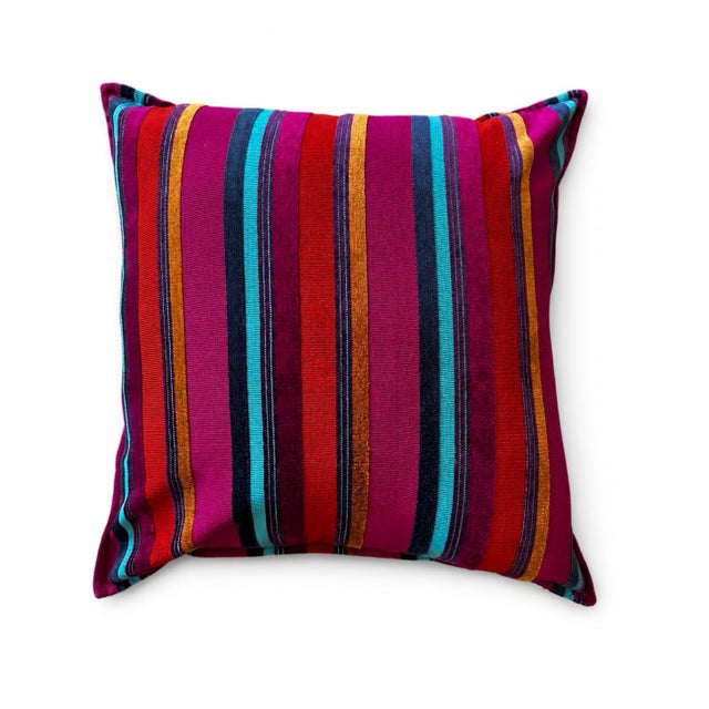 A striking pair of custom designer throw pillows featuring vibrant woven striped fabric in rich shades of fuchsia,...