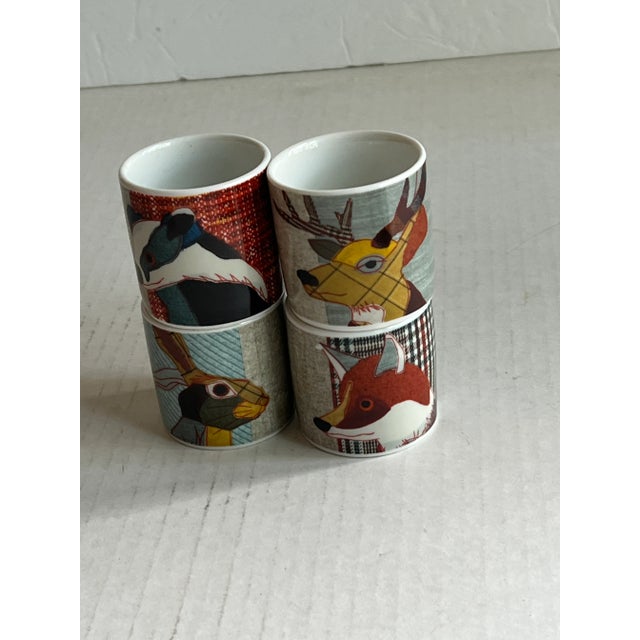 Add these whimsical egg cups to your table. Each cup has a "fabric" background and animals from the British countryside,...