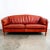 Gorgeous rust / red 3 seater sofa on wood legs. Rich and thick top grain leather throughout. Recently imported from Denmark.