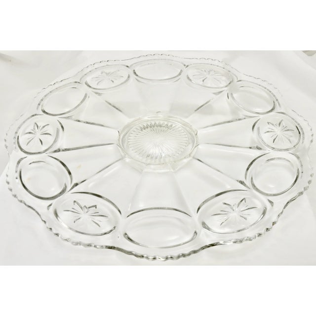 This grand sized 18 inch vintage sparkling clear glass footed tray with petal like scallop rim accented by a medallion and...