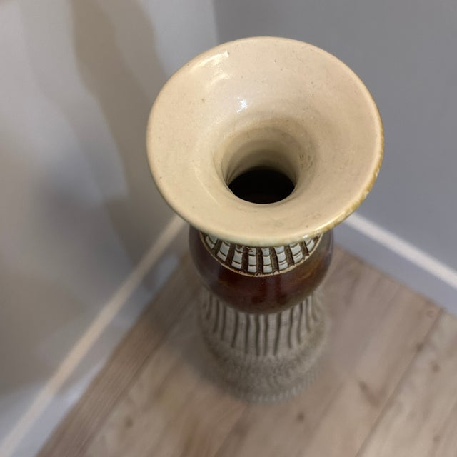 A magnificent, investment-grade monumental studio art pottery floor vase standing an imposing 29 inches tall. This...