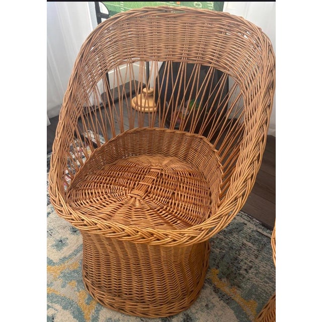 Beautiful set of 2 vintage wicker rattan accent chairs featuring a sculptural barrel silhouette and airy woven design that...