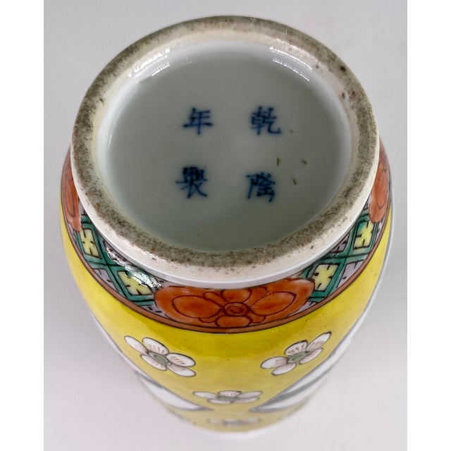 A finely decorated Chinese porcelain vase executed in the vibrant famille jaune palette, featuring hand-painted figural...