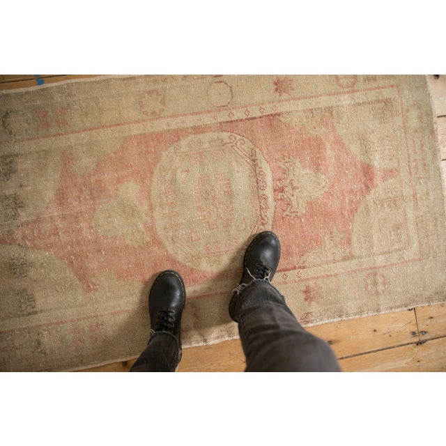 :: Roundel center medallion adorned at either end by trefoil arrowed finials atop an open field with corner spandrel...