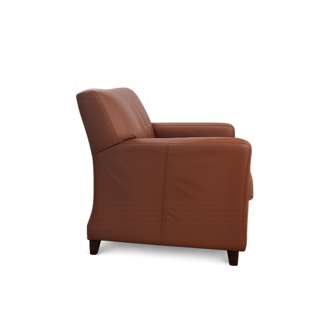 A beautifully crafted Bradington & Young brown leather chair that exudes timeless elegance and superior craftsmanship....